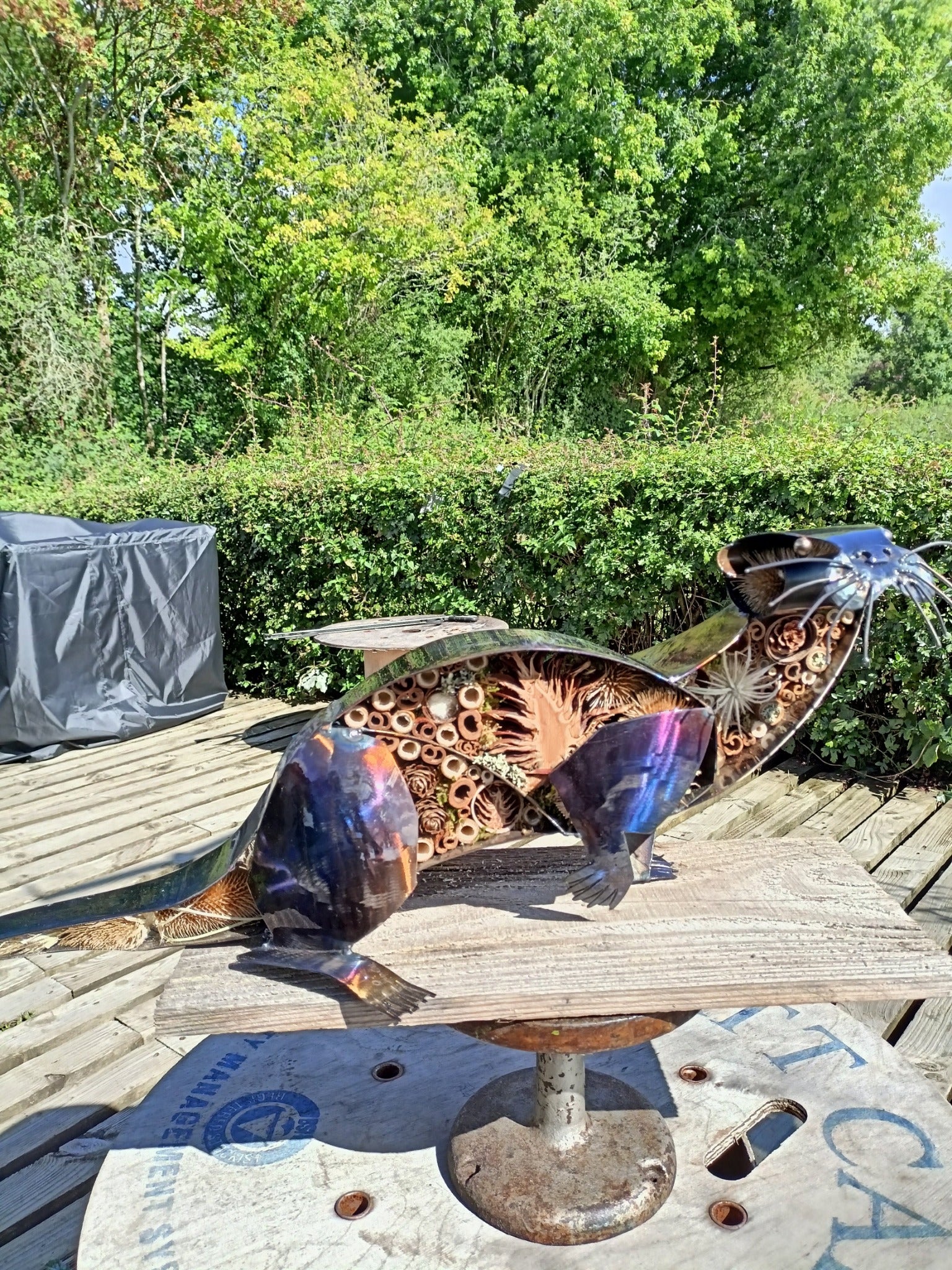A beautiful Otter made from metal with patterned organics