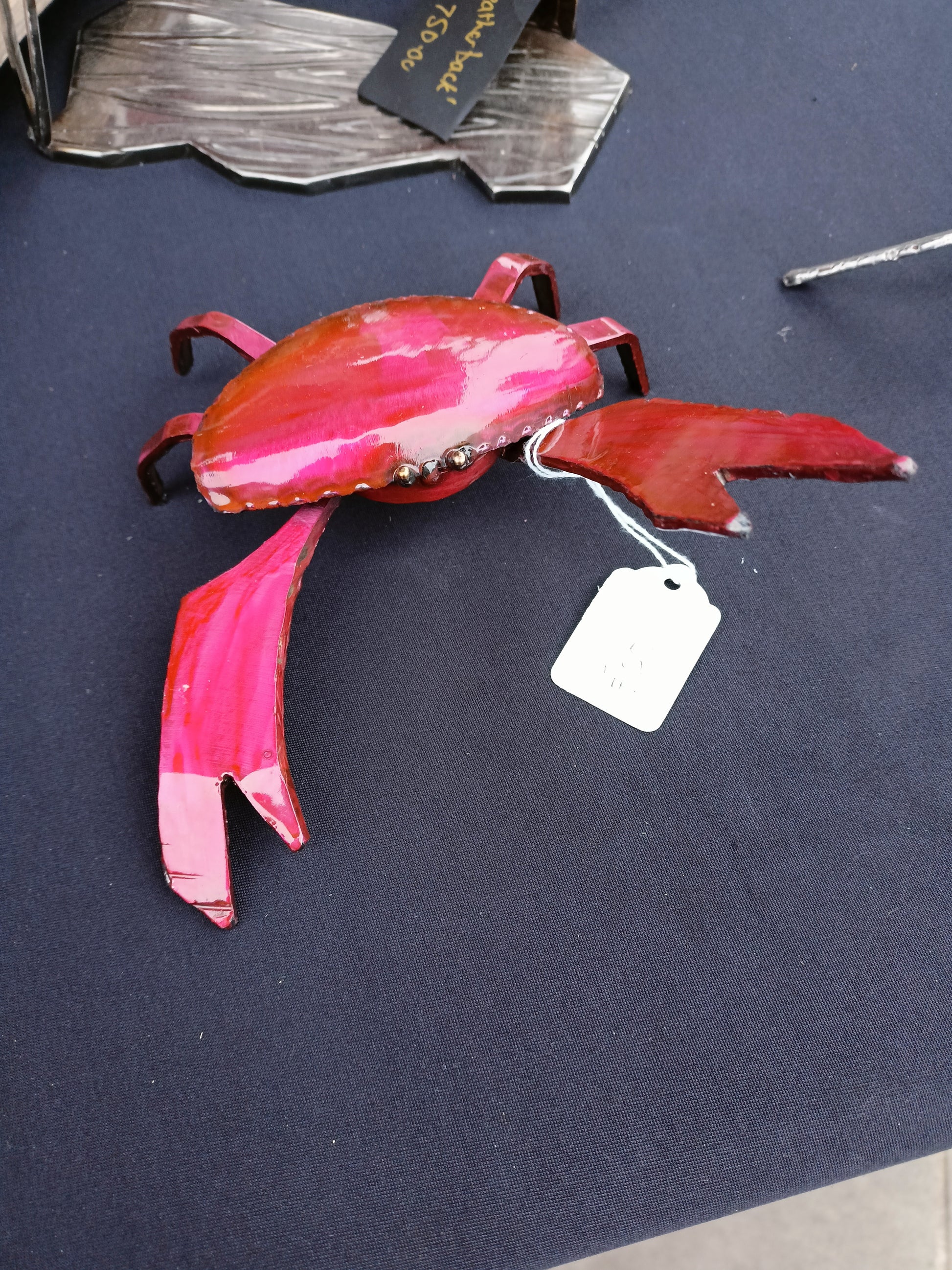 small red crab made of metal