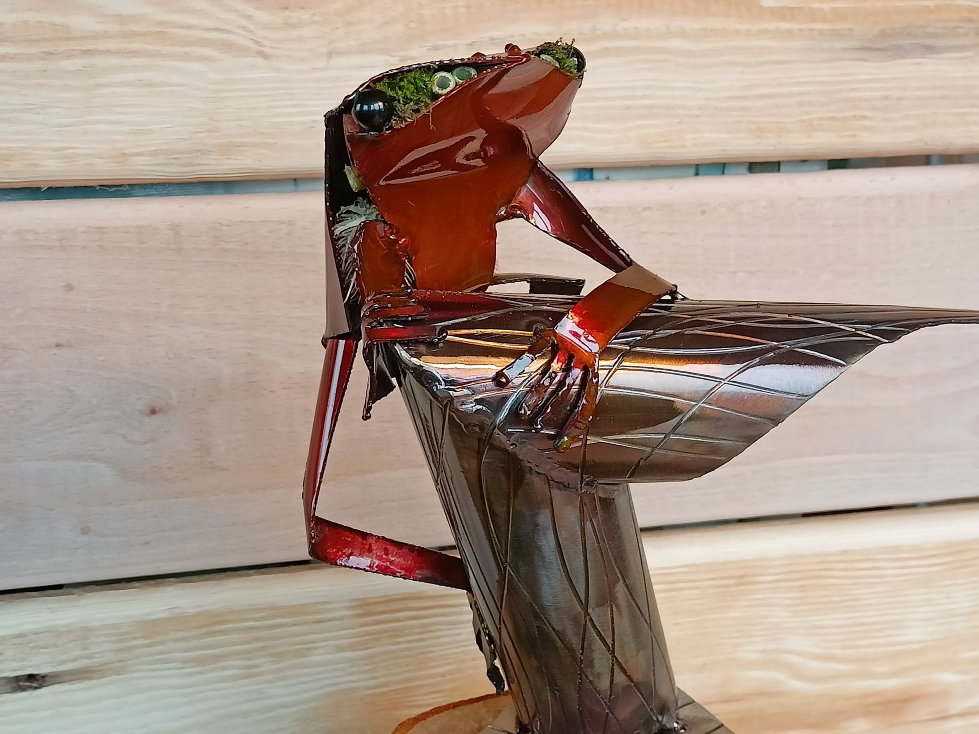 Red Tree Frog sitting on a branch inspired sculpture made from 100% upcycled metal