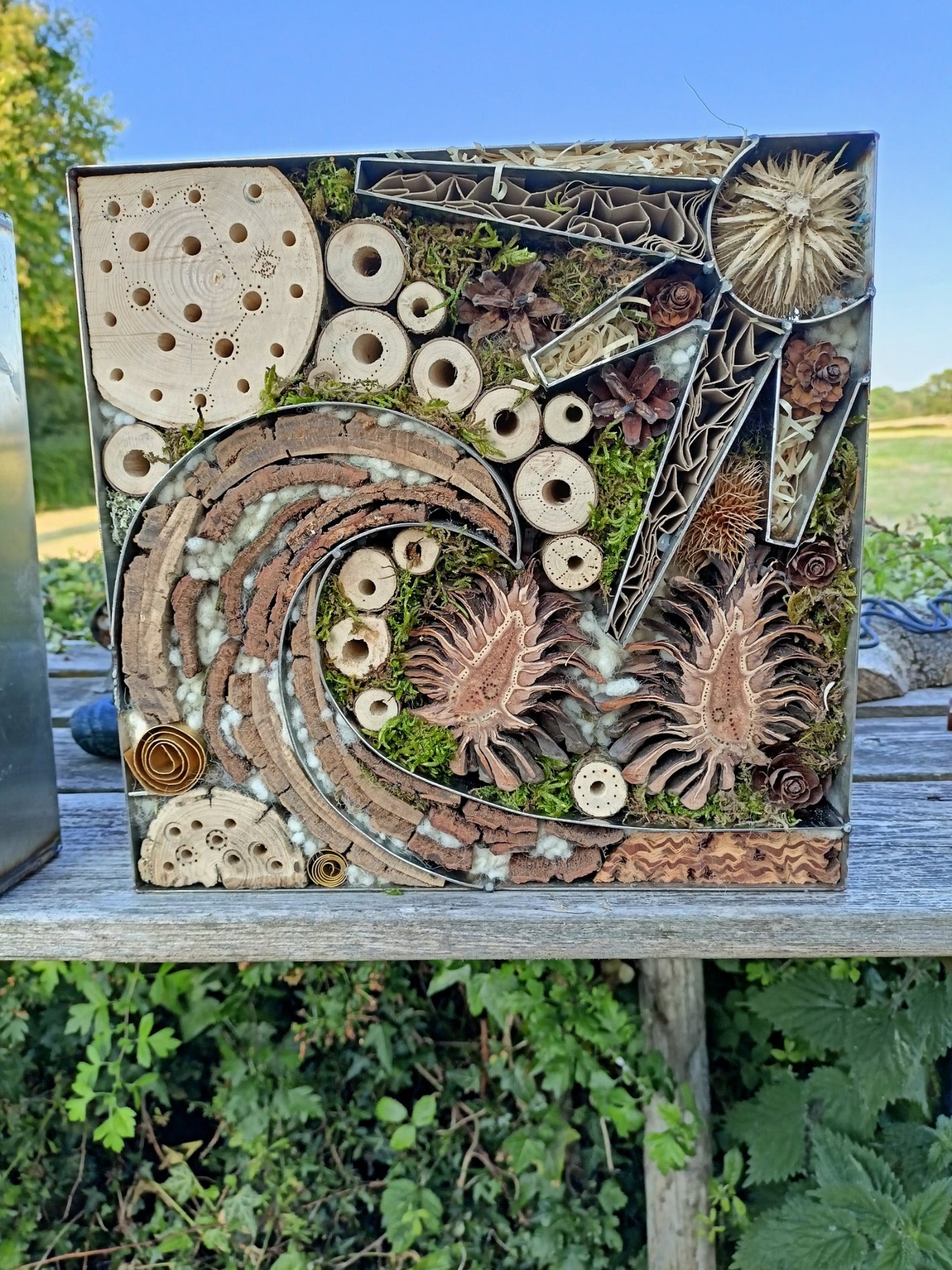 Abstract wall art using a combination of metal and plant materials