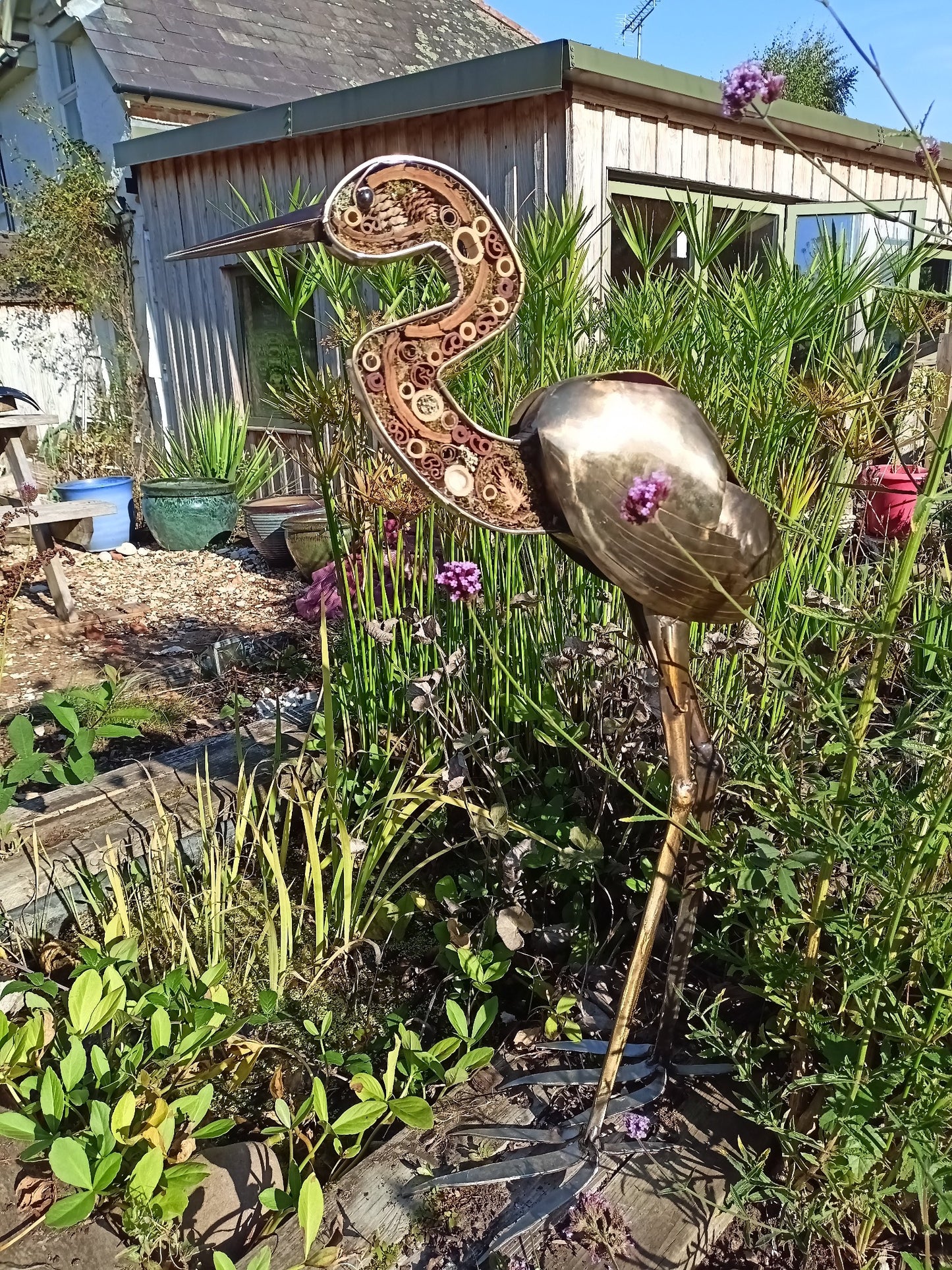 Nadia the Heron in stainless steel with integral insect refuge.